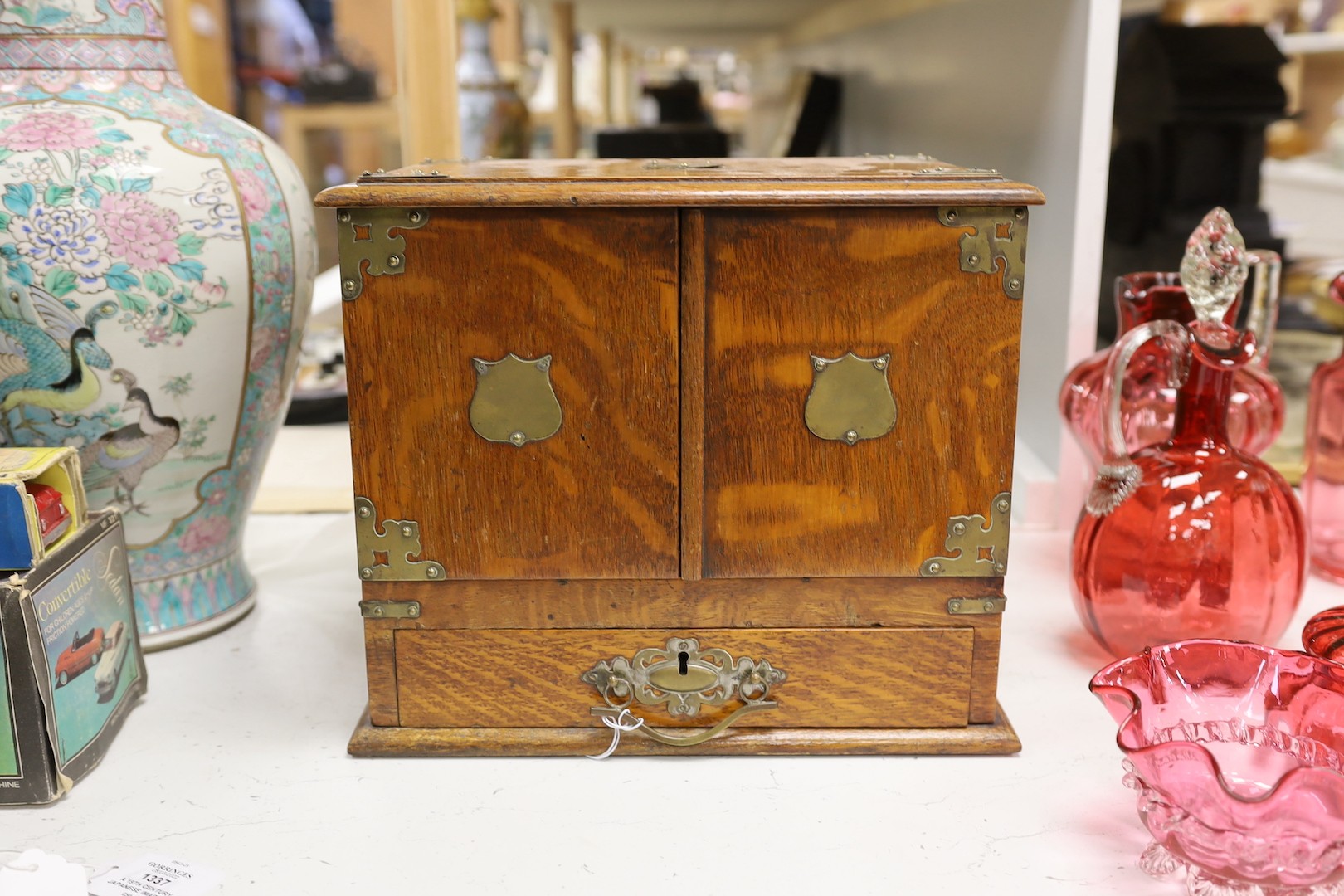 A 19th century oak stationery cabinet with brass mounts, 28.5 cms high x 33cms wide.